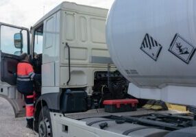 Dangerous goods tank truck driver getting into the cab safely
