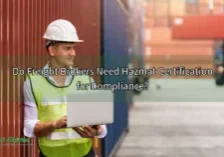 Featured image of a freight broker near a large container for the "Do Freight Brokers Need Hazmat Certification for Compliance?" article